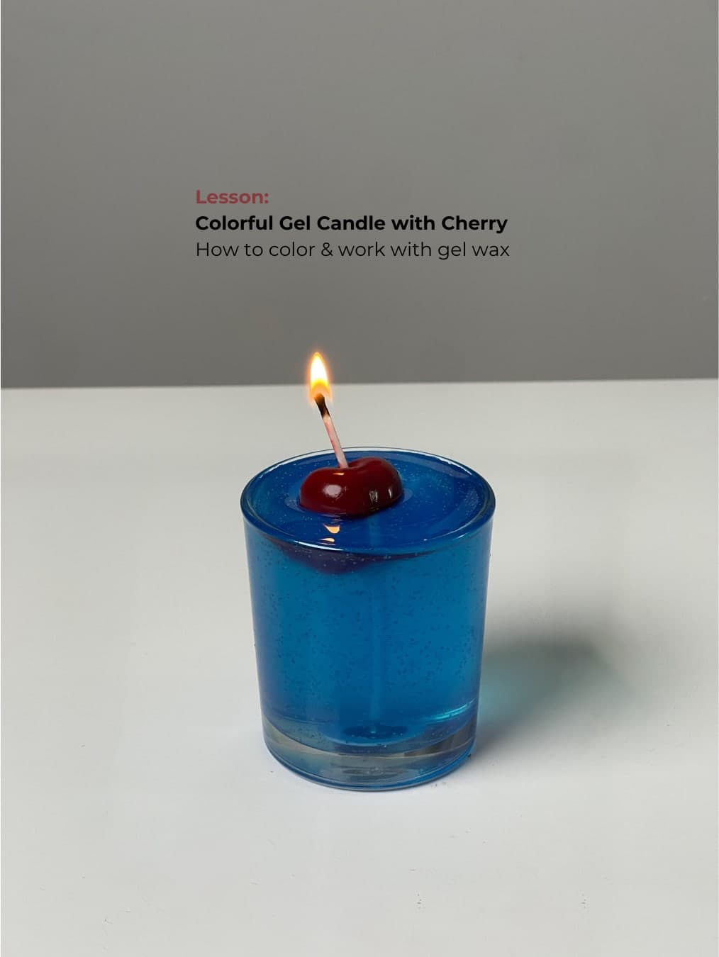Colourful gel candle with a cherry